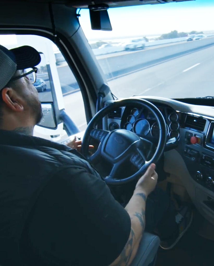 Driver behind the wheel of autonomous Plus truck