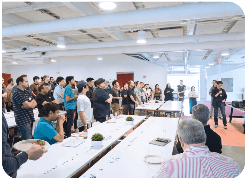 Large group of Plus employees watching presentation