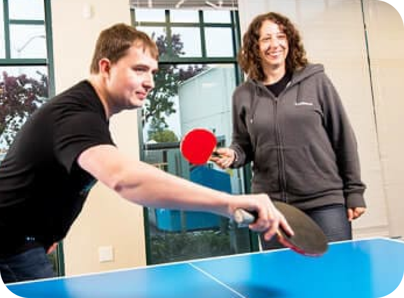 Plus employees playing table tennis