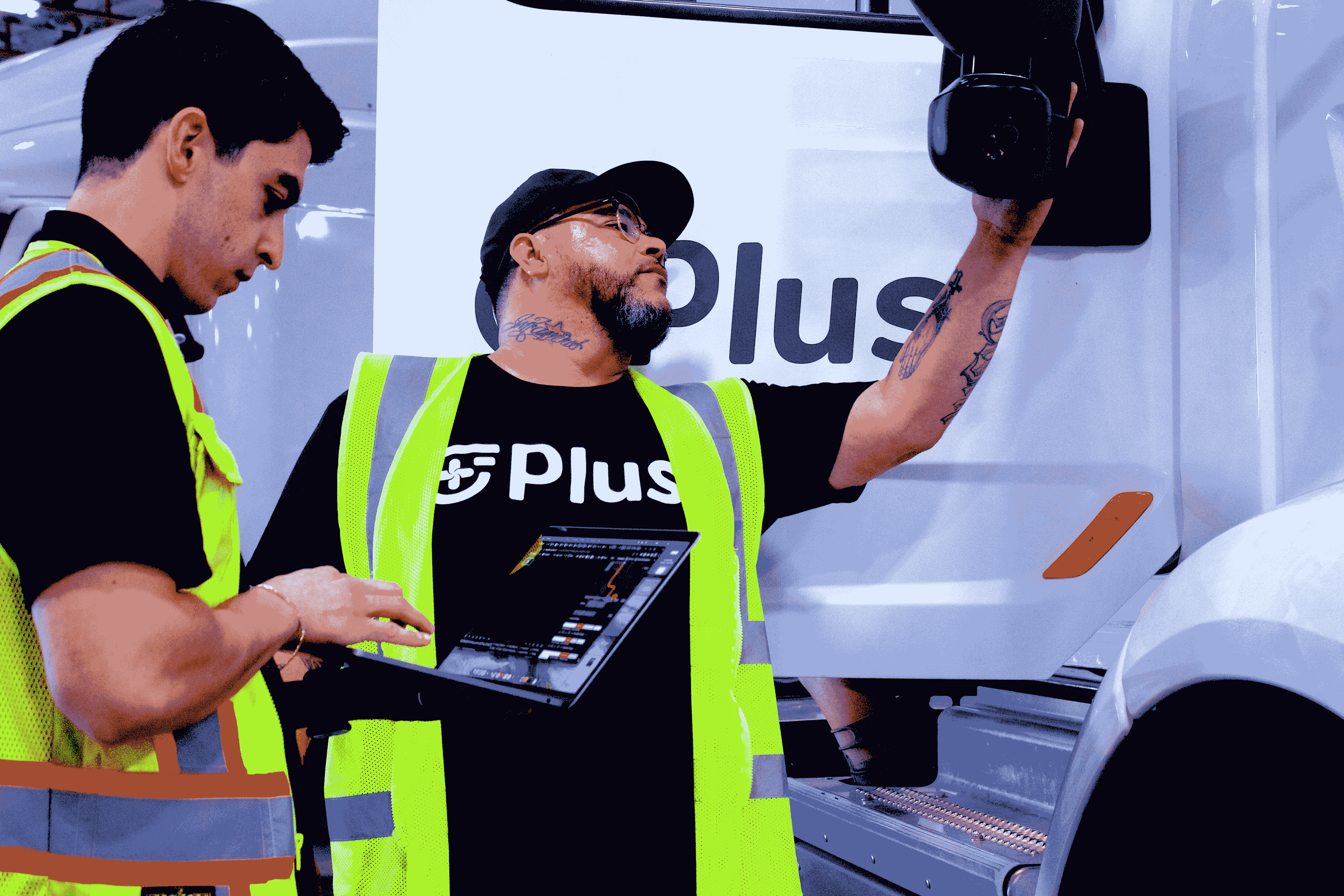 Plus employees checking cameras on autonomous Plus truck