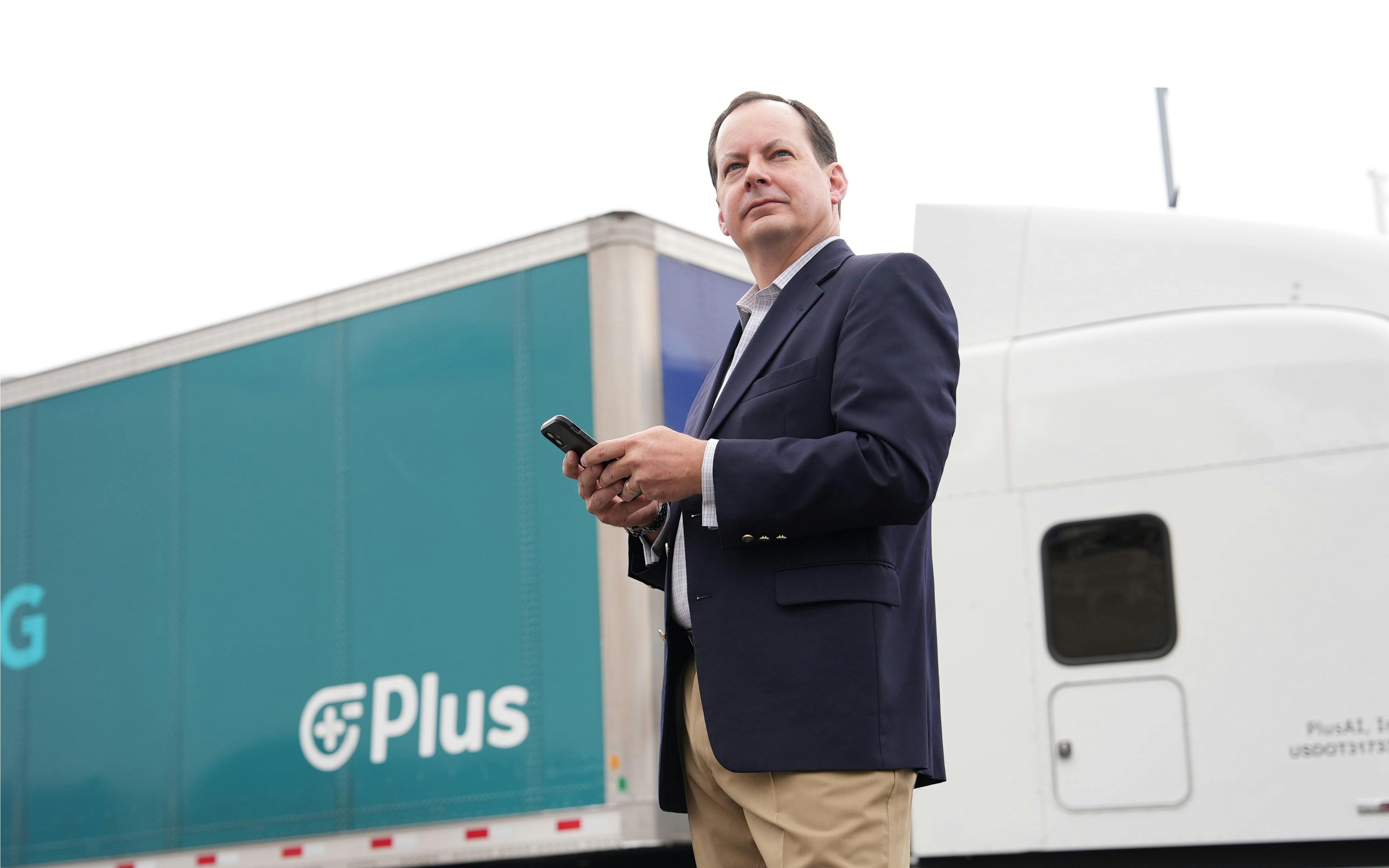 Plus Vice President of Government Affairs and Public Policy Wiley Deck in front of Plus truck