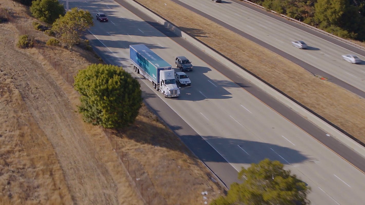 Plus self driving commercial truck driving on highway